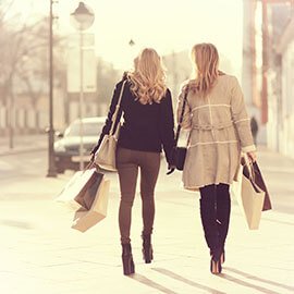 Two women shopping down the street