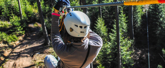 A person starting down a zipline