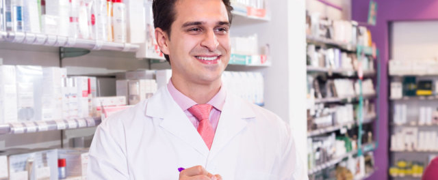 A man in a lab coat in a pharmacy