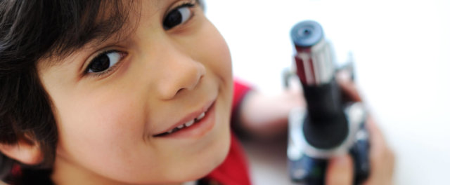 A boy with a microscope