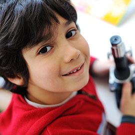 A boy with a microscope