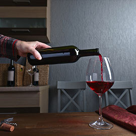 Pouring a glass of wine from a wine bottle