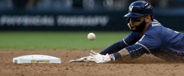 A baseball player sliding into base