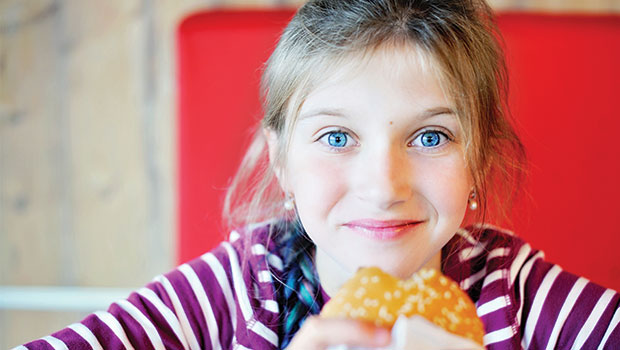 girl eating hamburger