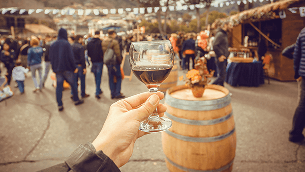 holding wine glass at festival